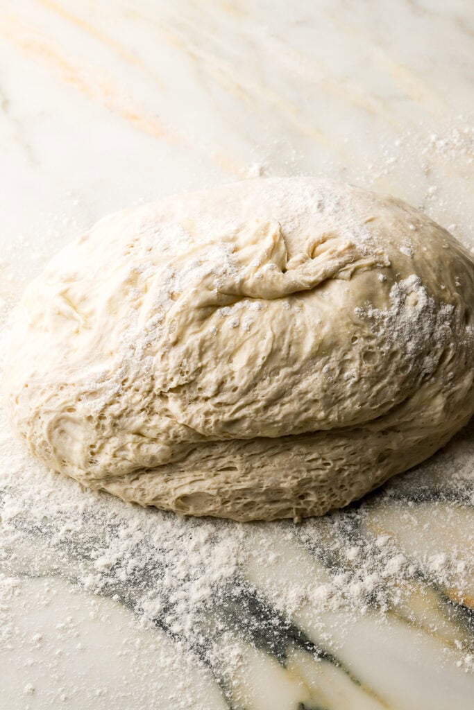 ciabatta dough flopped onto a floured surface