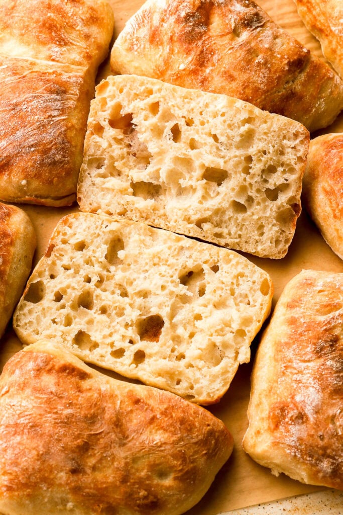 fluffy ciabatta rolls sliced in half to show the inside crumb texture