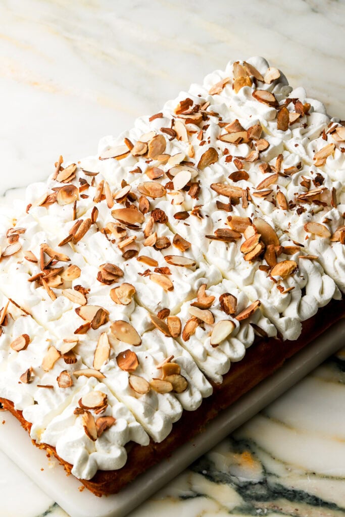 cake sliced and topped with toasted almonds