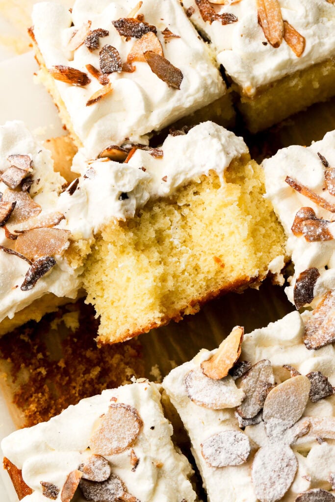 close up of almond croissant cake sliced and a bite taken out
