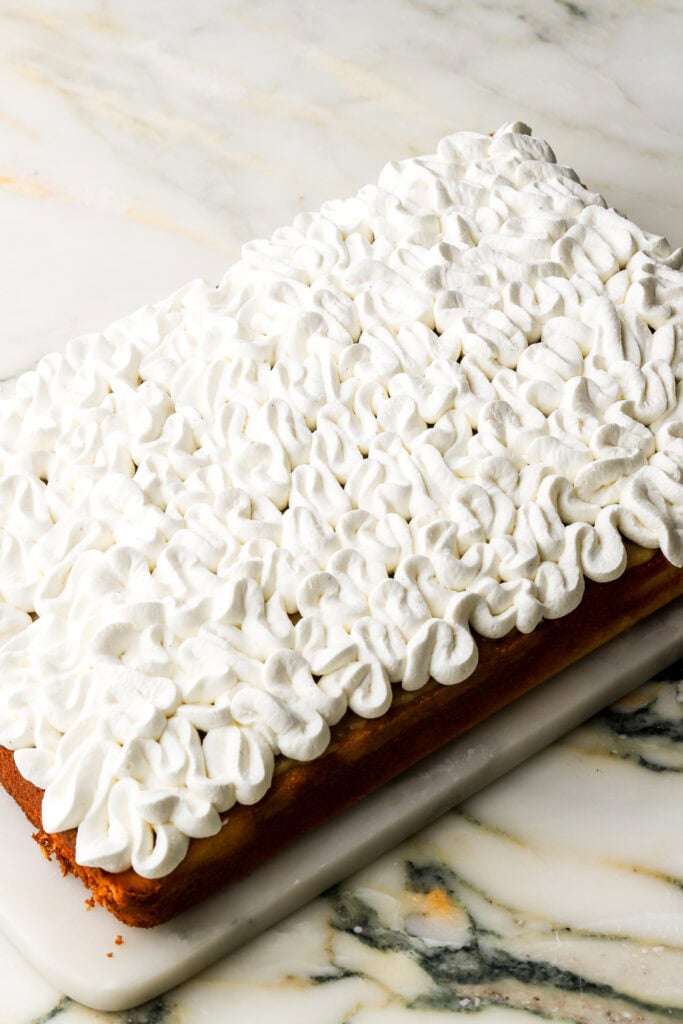 chantilly cream piped on top of almond filling