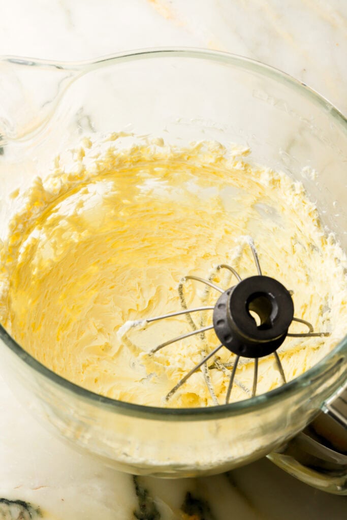 butter whipped until pale in a glass bowl with whisk attachment