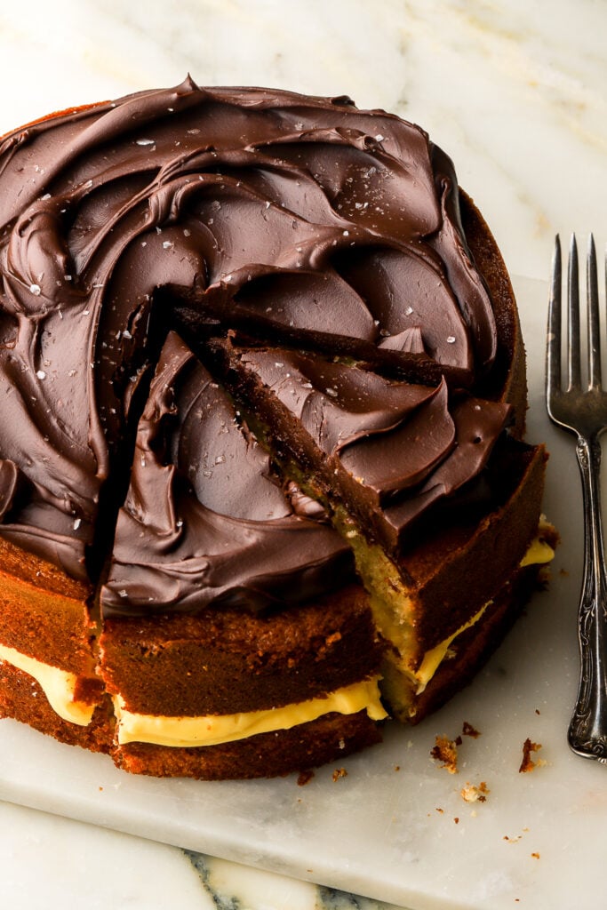 boston cream pie on a marble board and sliced