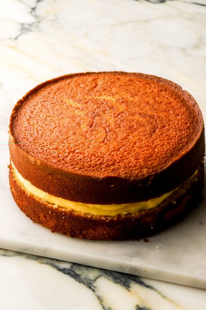 Top layer of cake placed on top of the pastry cream