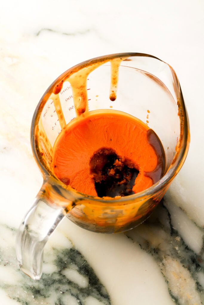chilled broth with the tallow risen to the top in a measuring cup