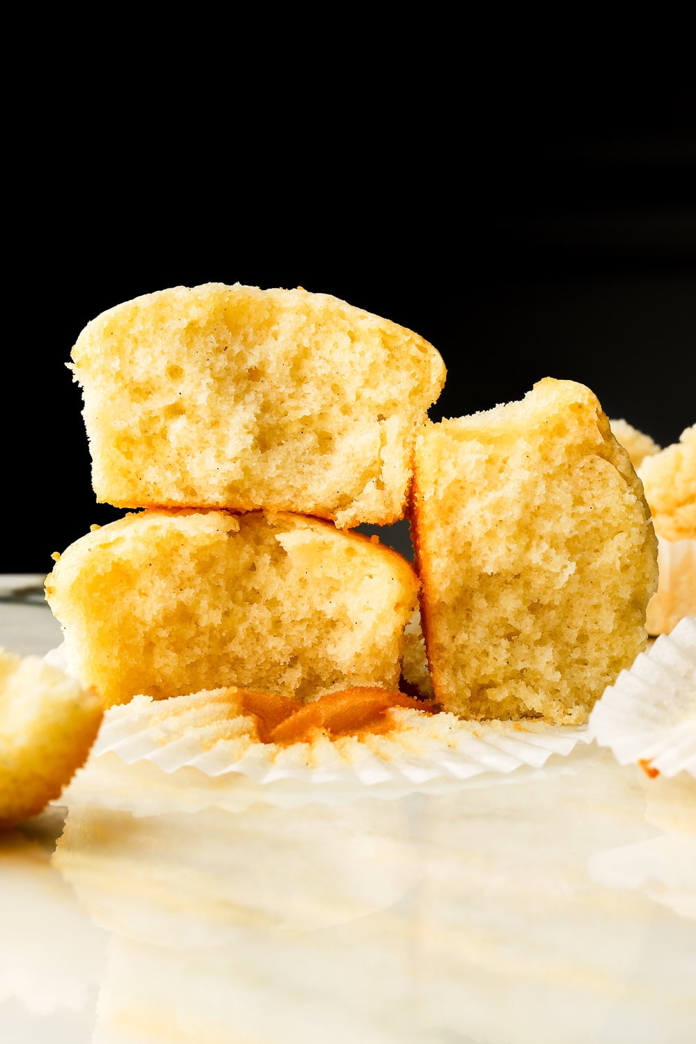 three cupcakes showing the inside crumb with a black background