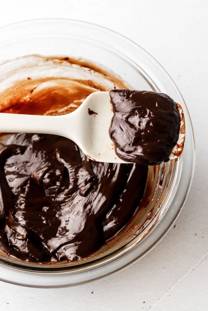 oil chocolate ganache in a bowl with a spatula showing up close