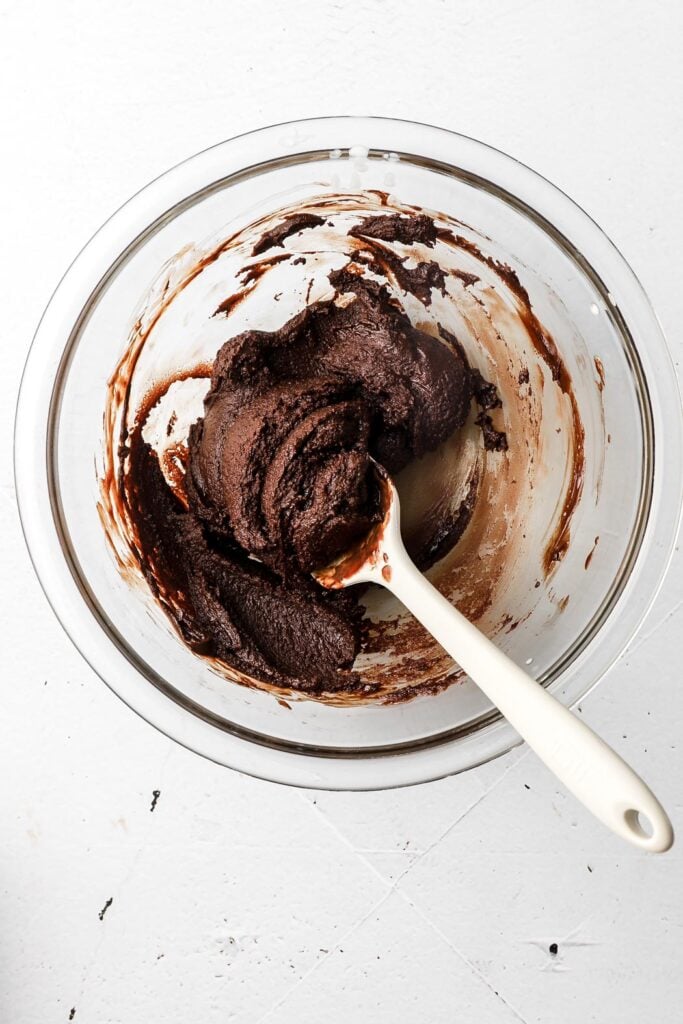 grainy chocolate ganache in a bowl with a spatula