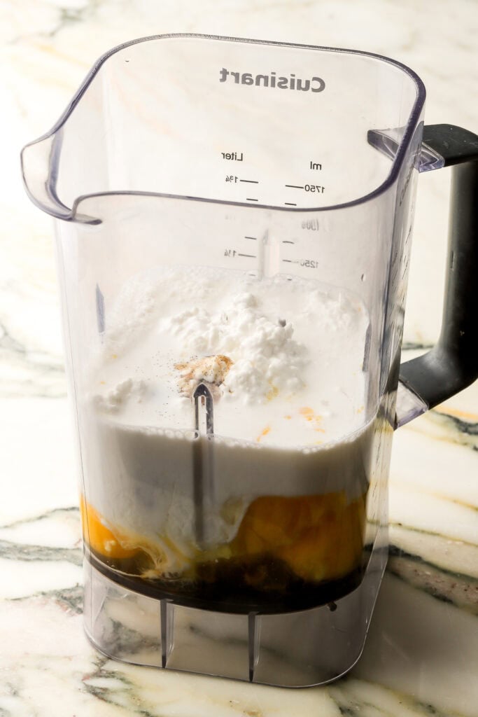blender full of cottage cheese, eggs and milk before blending