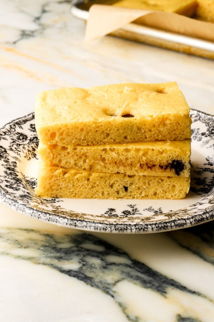 stack of pancakes made in a sheet pan on a black and white plate