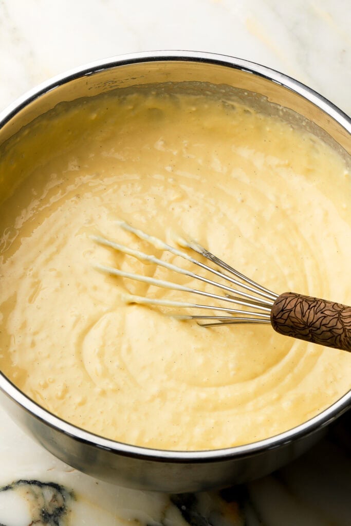pancake batter finished in a bowl with a whisk