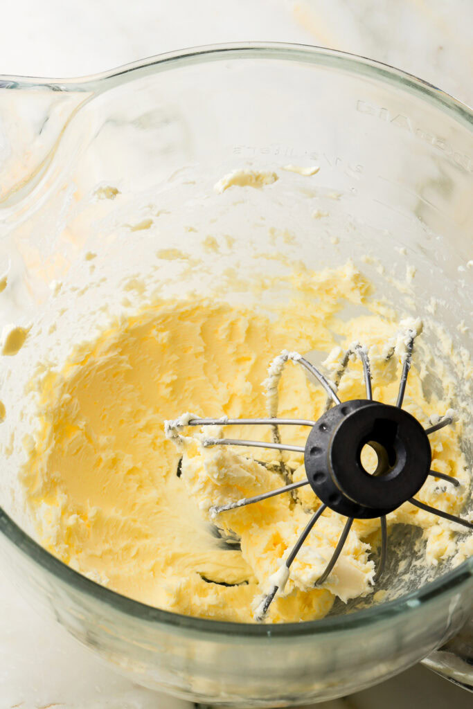 butter whipped in a glass bowl with whisk attachment