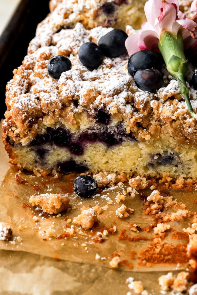 side of blueberry coffee cake sliced on a the baking sheet