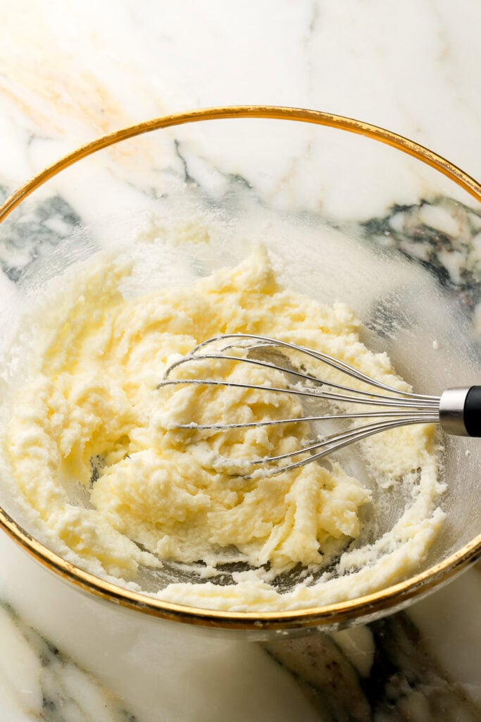 butter and sugar mixed together in a glass bowl