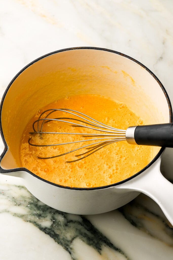 eggs and sugar whisked together in a pot