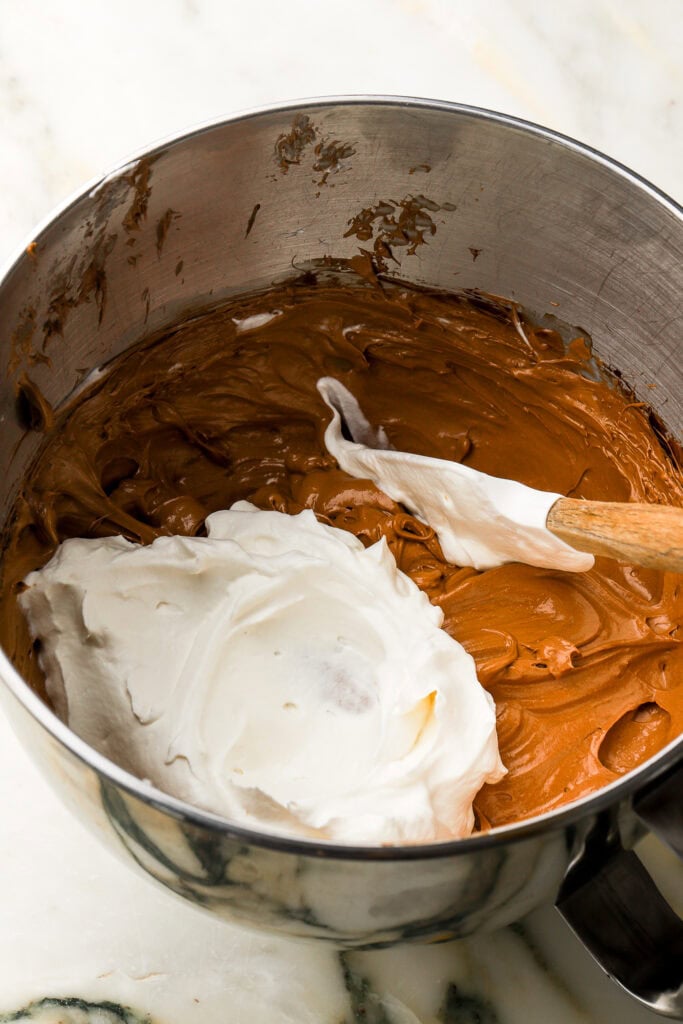chocolate mixture and whipped cream in stand mixer bowl