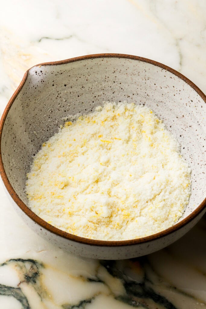 sugar and lemon zest rubbed together in a bowl