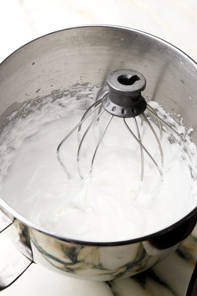 egg whites whipped with sugar until fluffy in a mixer bowl with whisk attachment