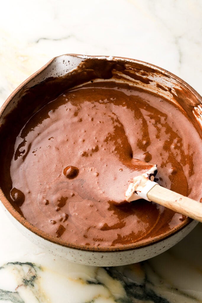 egg whites folded into cooled chocolate mixture in a bowl