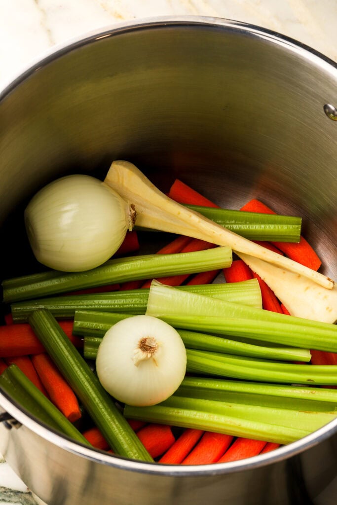 vegetables on the bottom of a large pot