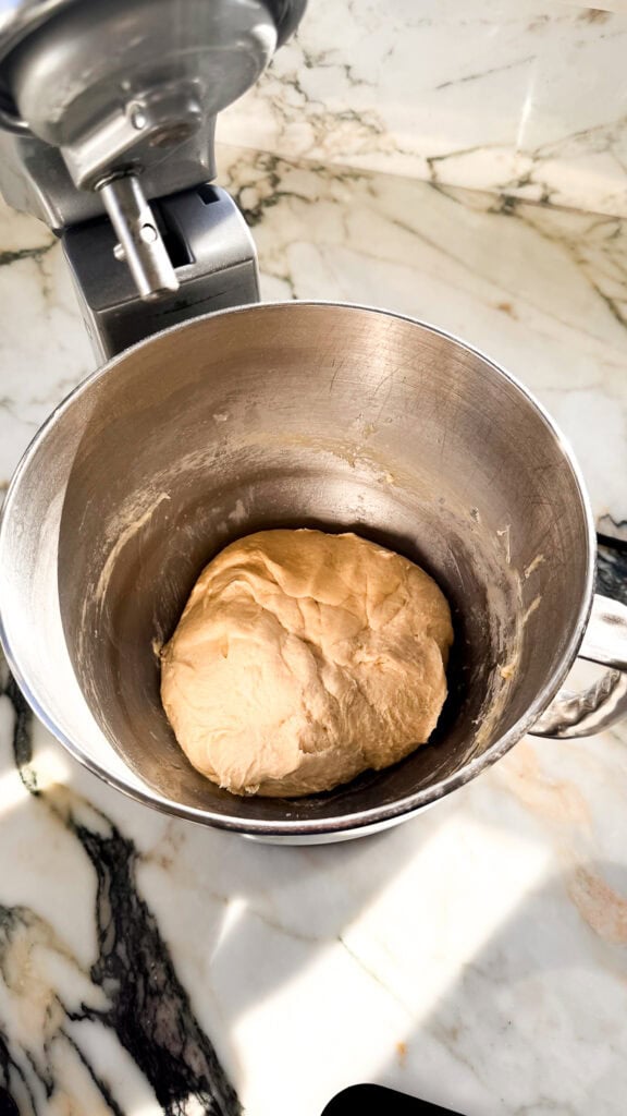 dough after butter is added and done in a stand mixer bowl with the hook attachment