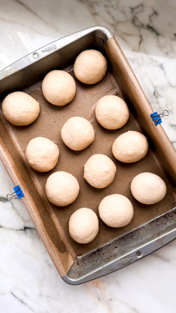 rolled dough balls in prepared pan before second proof