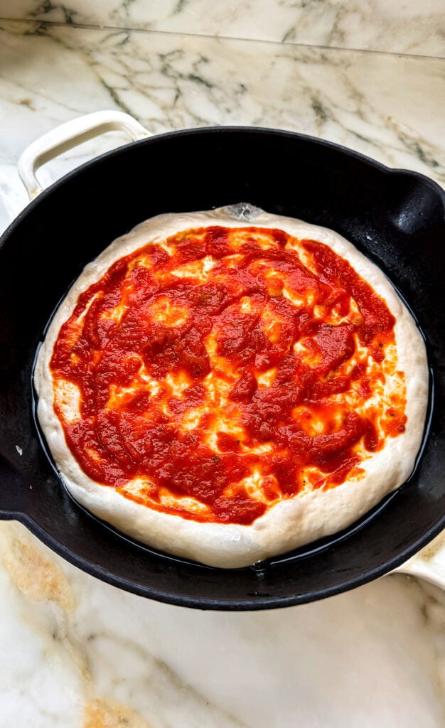 pan pizza topped with pizza sauce