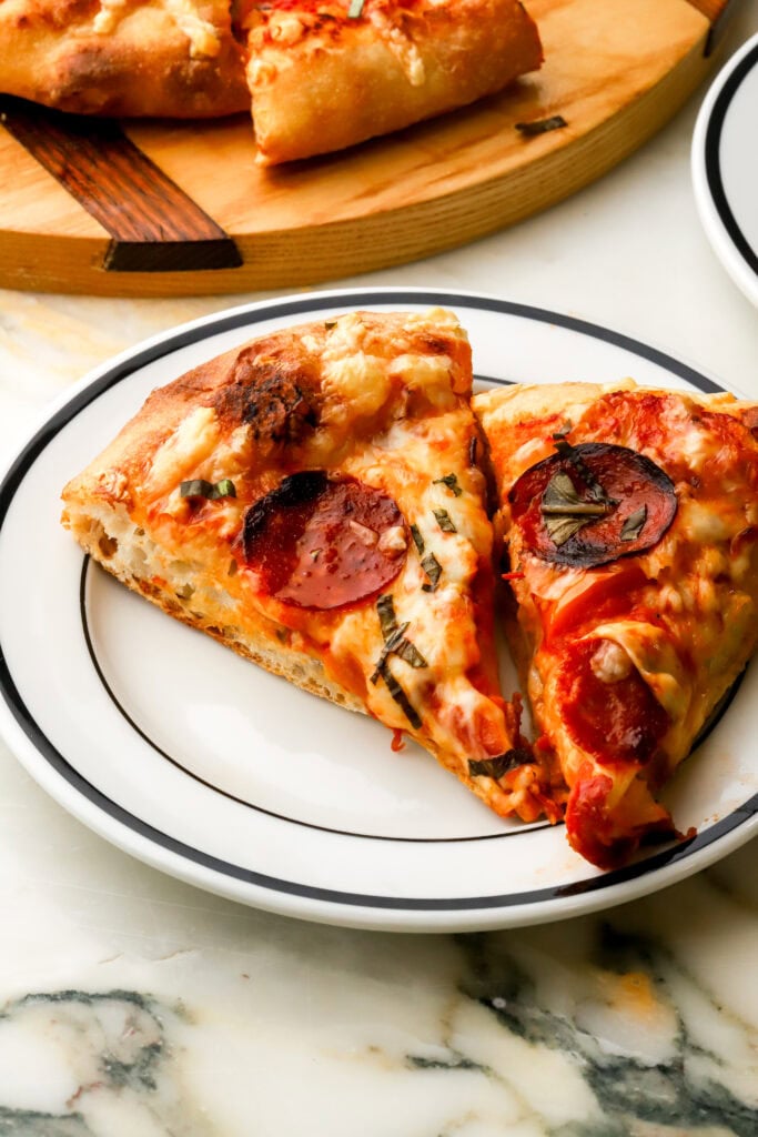 two slices of pepperoni pizza on a plate