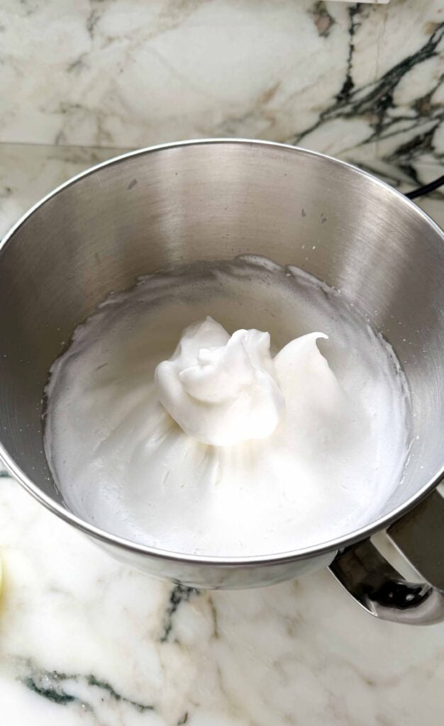 egg whites and sugar whipped in the metal bowl of a stand mixer until stiff peaks