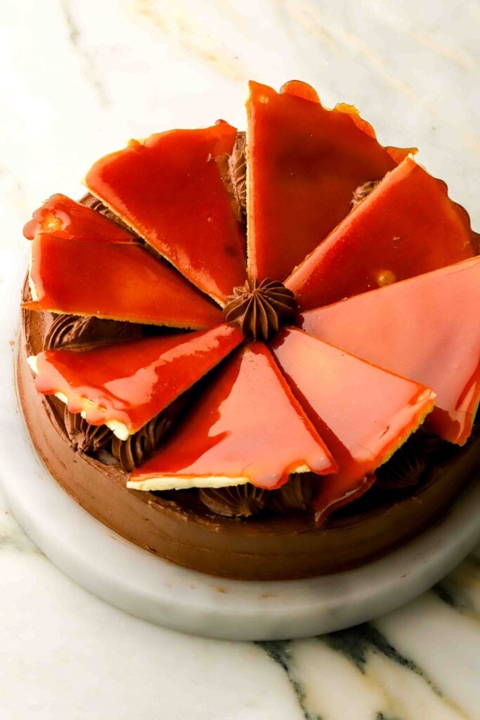 cake completely finished and decorated with caramelize sugar triangles on top