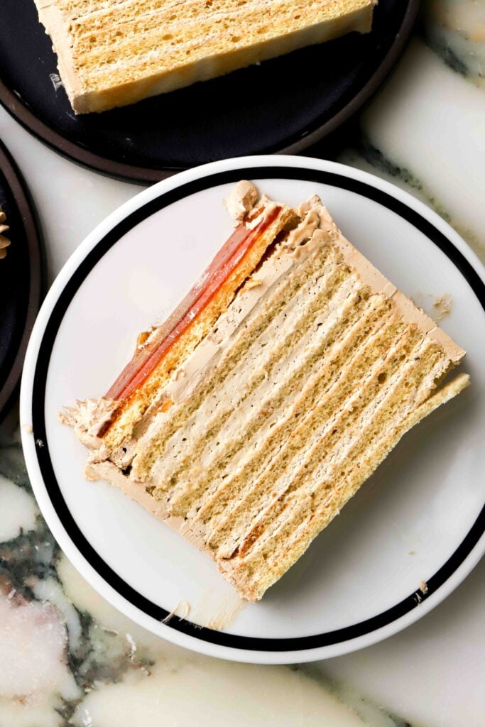 slice of coffee dobos on a plate showing all the layers