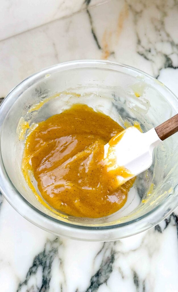 brown butter custard cooked, in a glass bowl with a rubber spatula