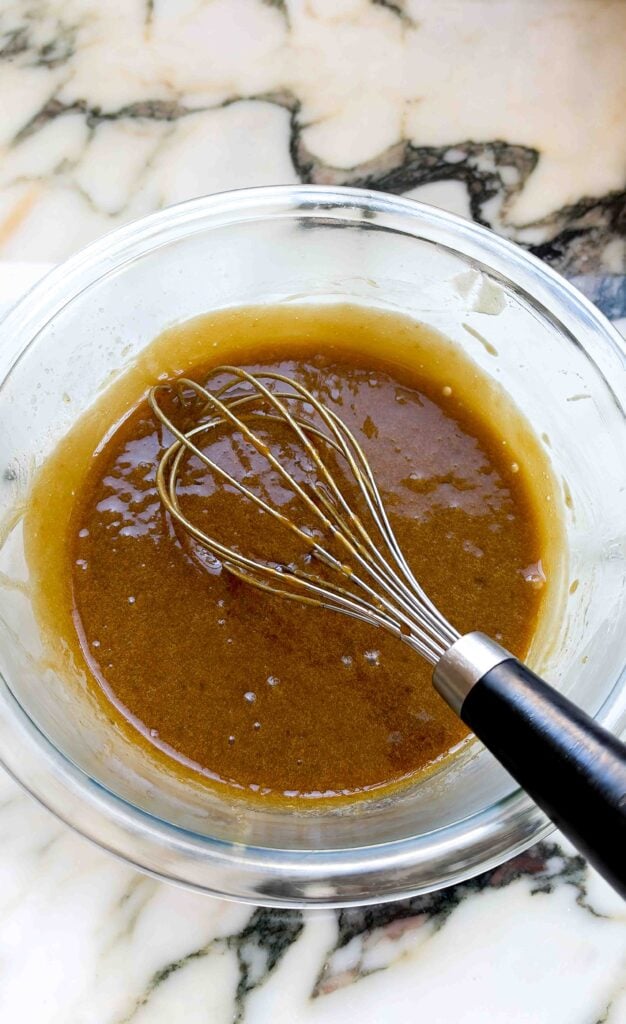 espresso custard cooked, in a glass bowl with the whisk