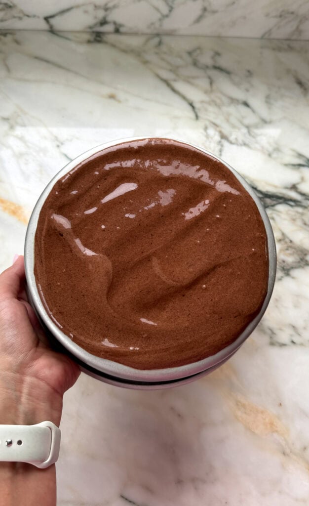 thin layer of cake batter spread on the backside of a round 8 inch pan