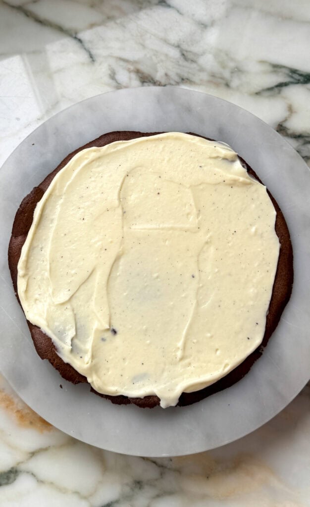 first layer of chocolate cake with vanilla diplomat cream spread on top